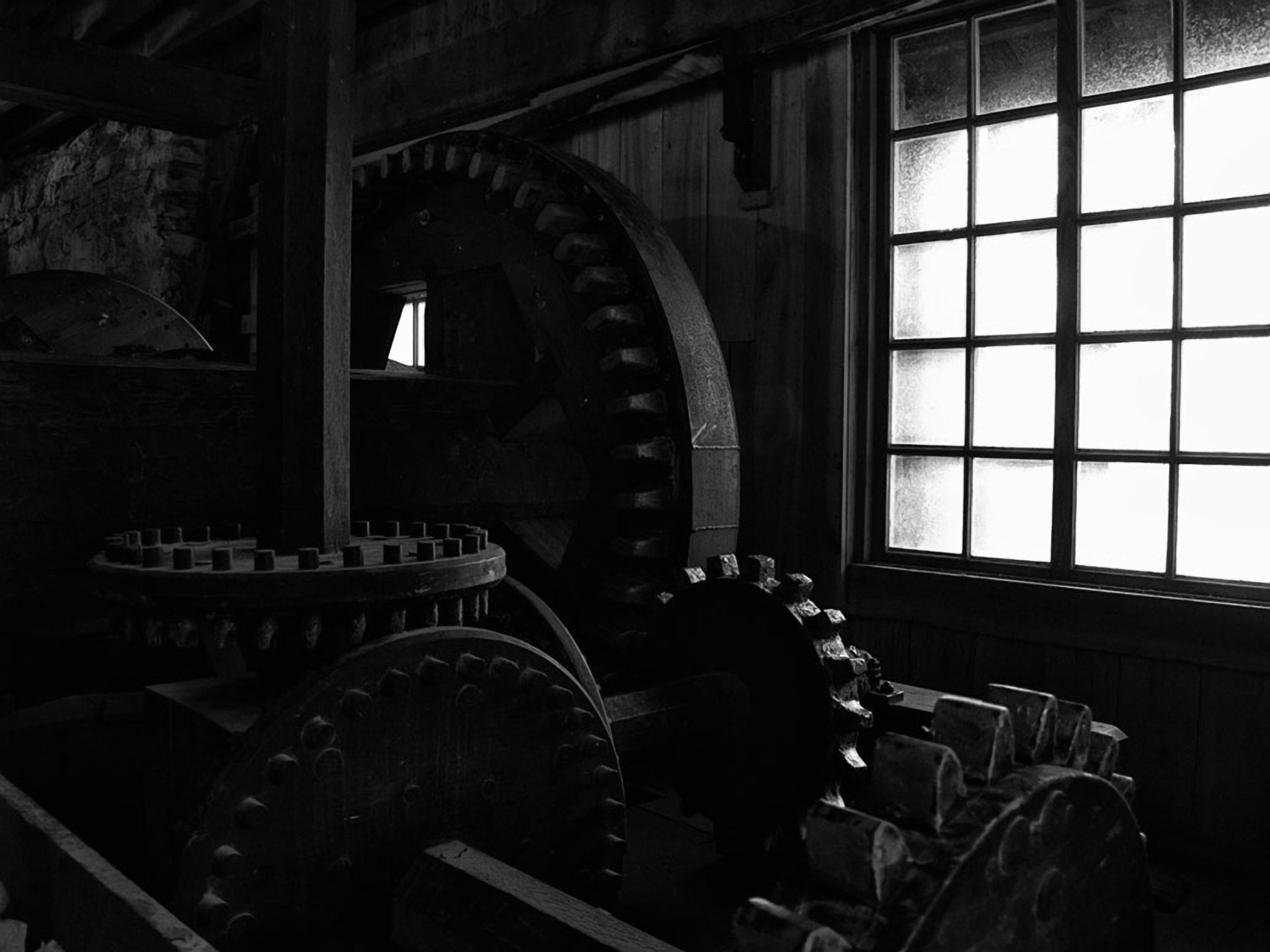 Industrial gears beside a bright window