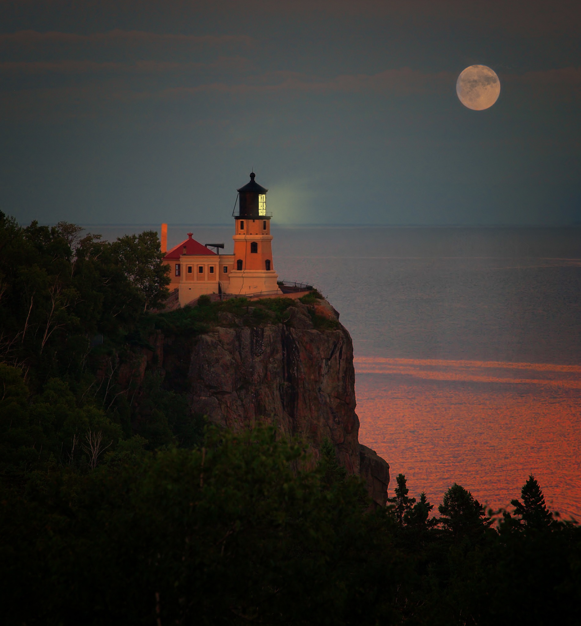 Lighthouse beneath a full moon